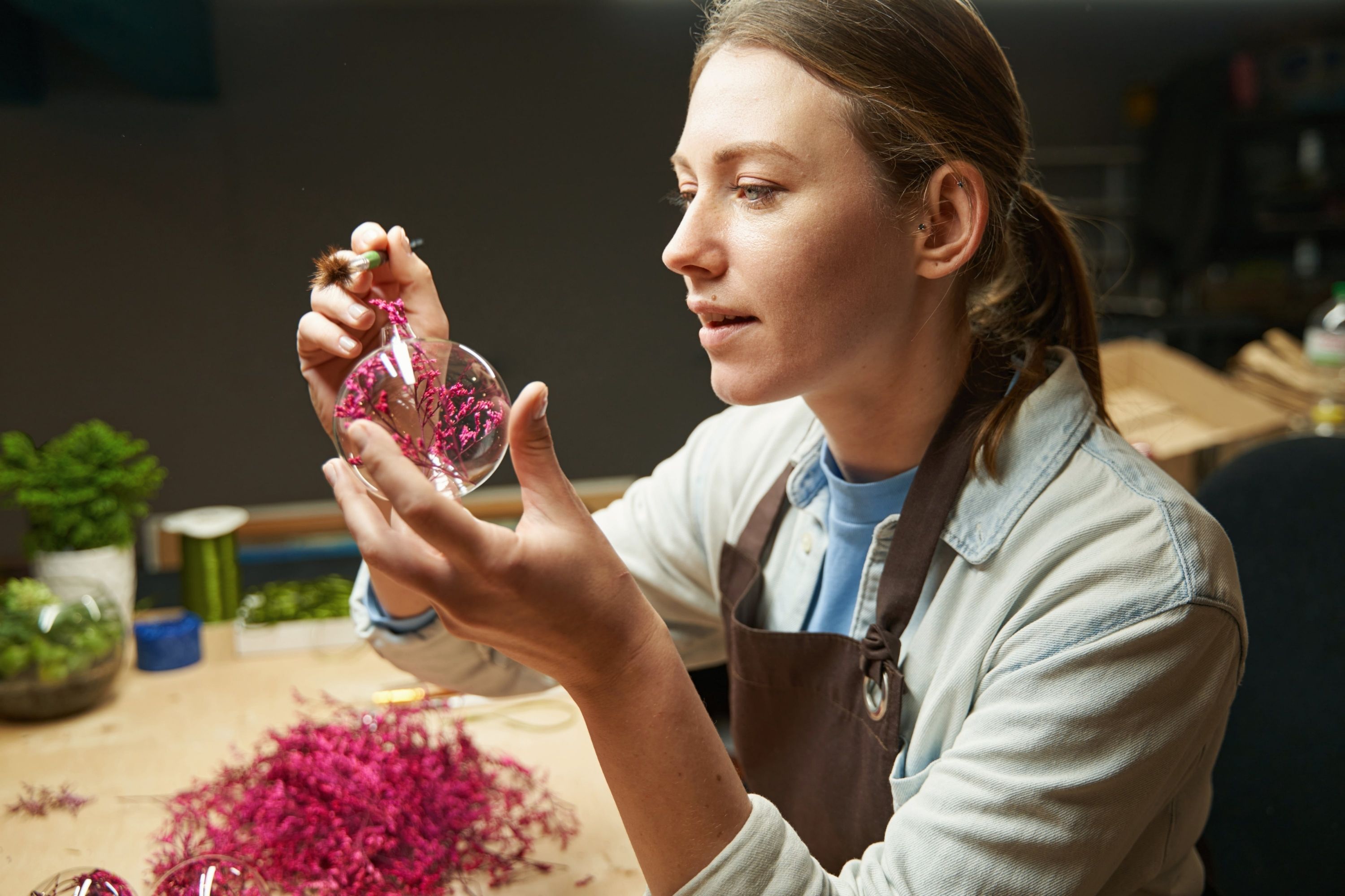 Florist making handmade oranments with preserved flowers